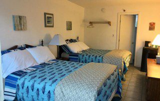 two beds in a room with pillows